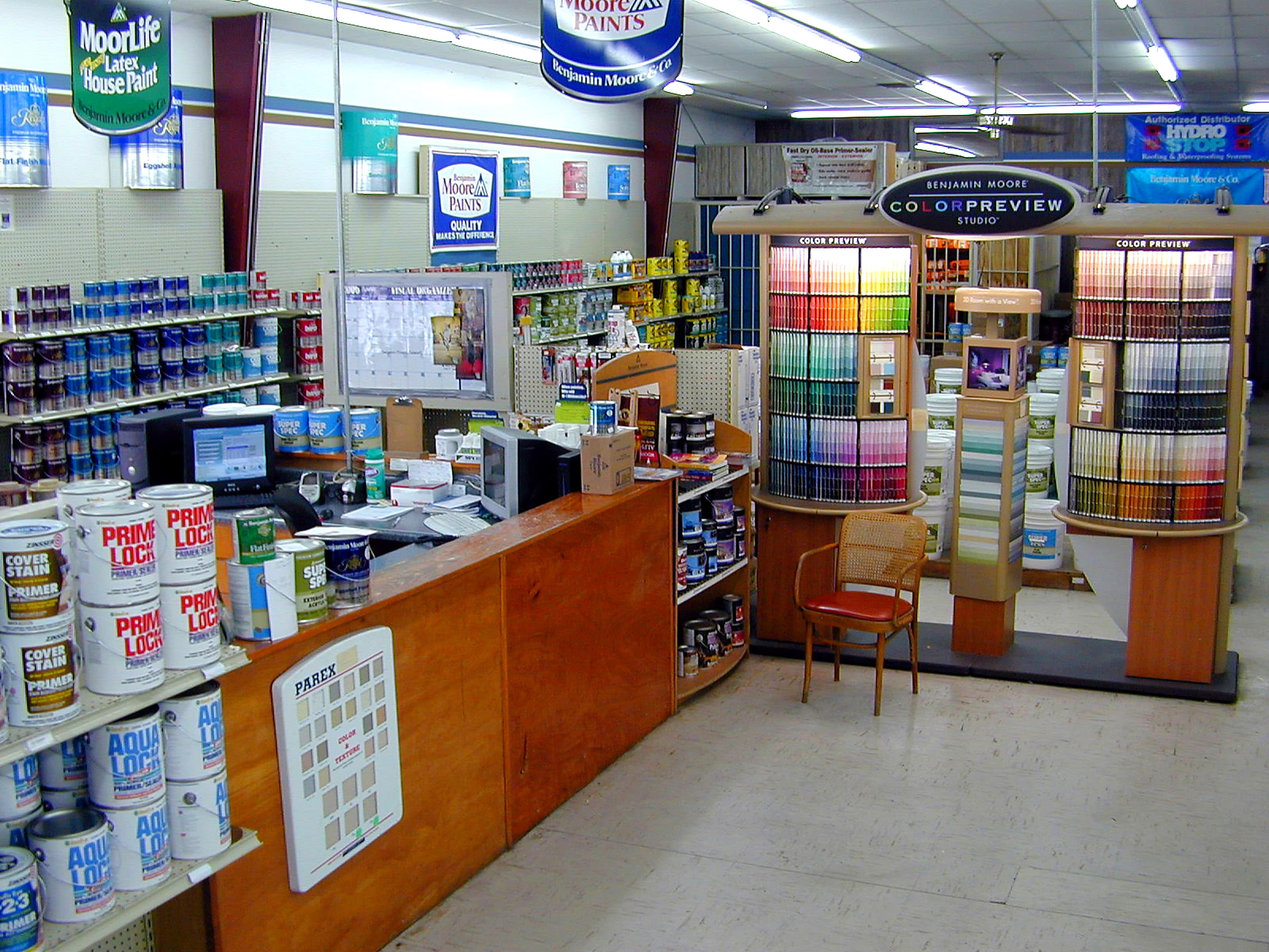 Coastal Hardware paint department with color chip displays, mixing stations, and Benjamin Moore signage