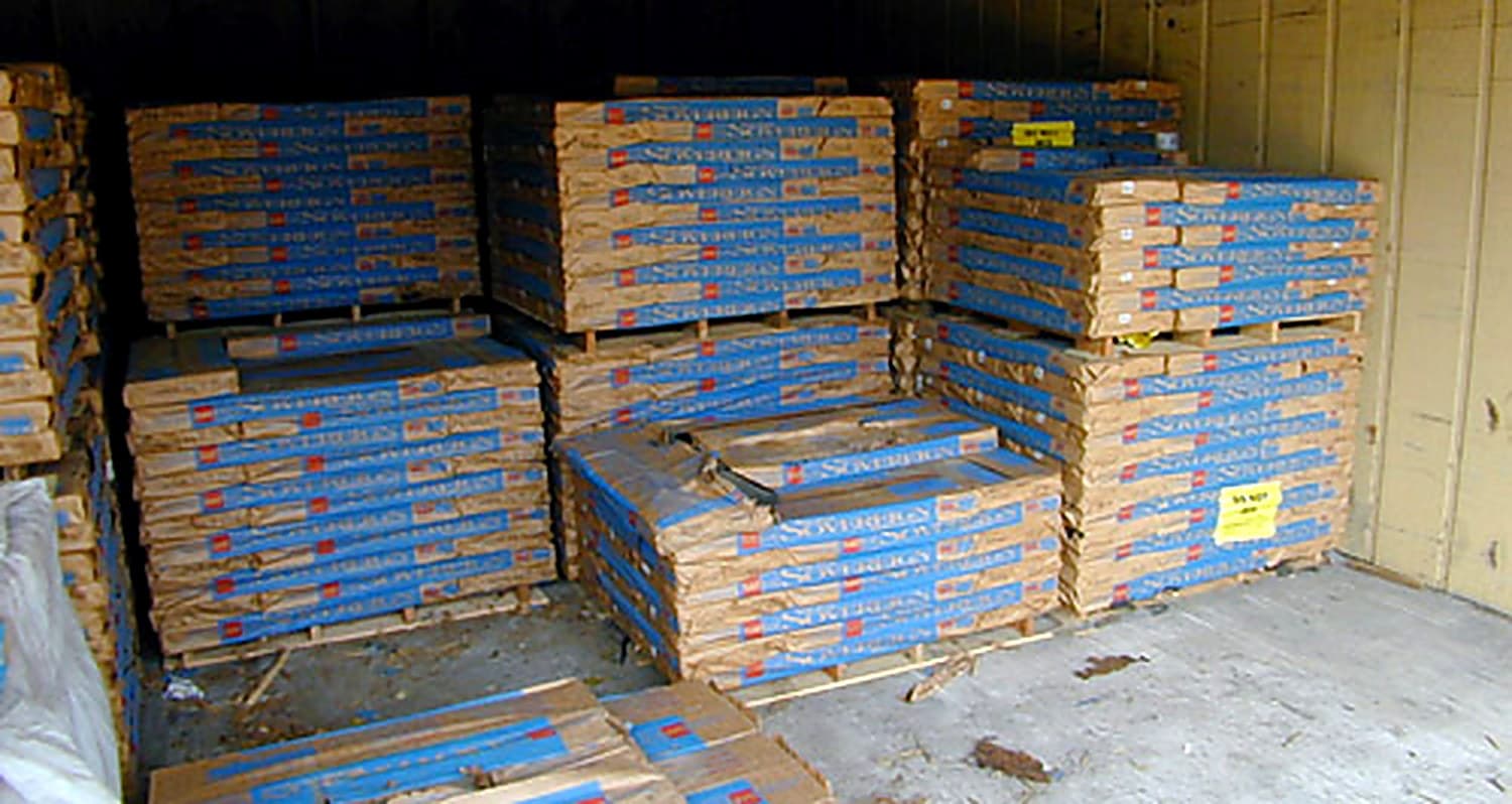Pallets of stacked GAF/ELK roofing shingles in the materials yard